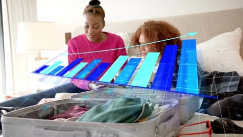 Couple on bed tapping device and causing 3D bar chart above open suitcase Stock Footage 333447726