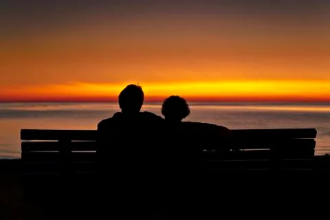 Couple on Bench at Sunset Stock Photos