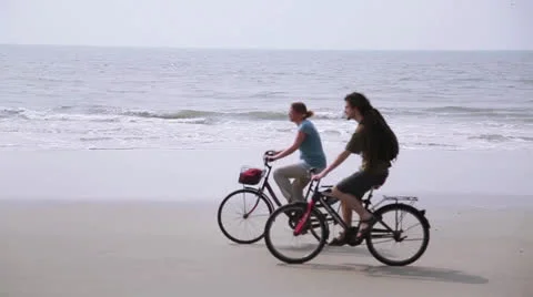 Couple by bicycle on the beach Stock Footage 26266028