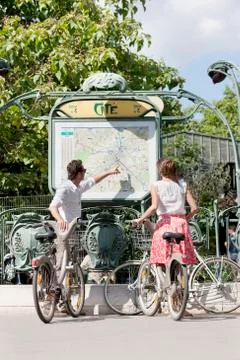 Couple with bicycles looking at a map, Paris, Ile-de-France, France Fotos Stock