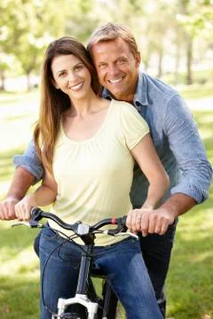 Couple with bike in park Stock Photos