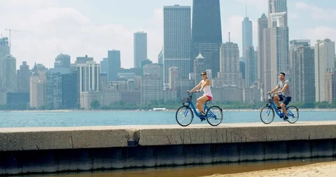 Couple Bikes Across Beach, Chicago Stock Video Pond5