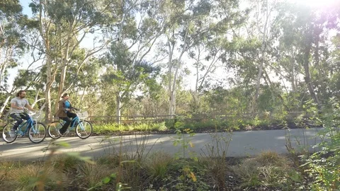 Couple on Bikes Tracking Shot Video stock 90012136