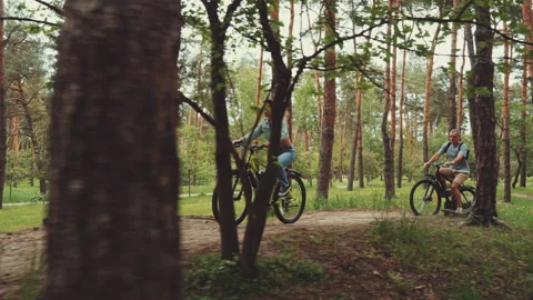 Couple Biking Through Forest Path or Trail Stock Footage 278148651