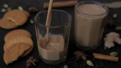 A couple of biscuits and tea served in transparent glass for morning breakfast Stock Footage 155824855