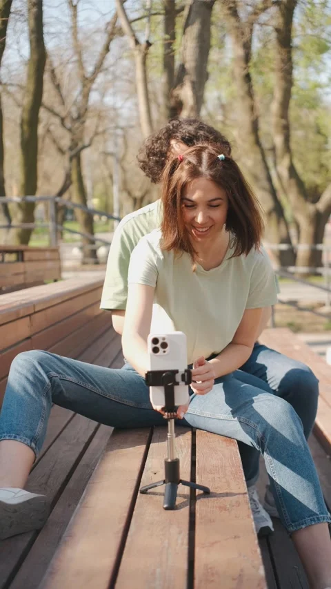 Couple of bloggers using smartphone camera and tripod recording dance moves for Stock Footage 277080984