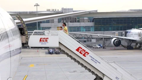 A couple boarding a Flight using the stairs in Ataturk Airport Stock Footage 87913274