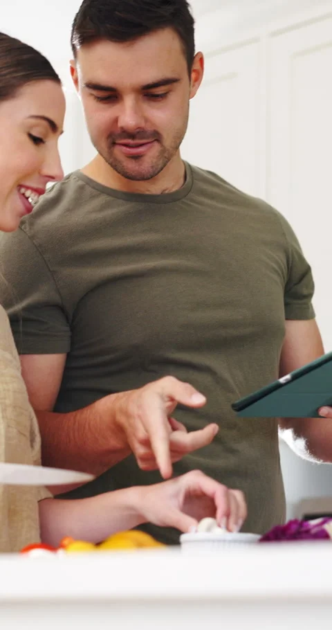 Couple, bonding and cooking with tablet in kitchen, online or learn culinary Stock Footage 337151210