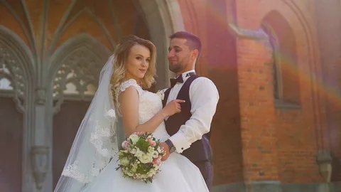 Couple Bride and Groom is Strolling in the Open Air over the Old Church Stock Footage 107786007