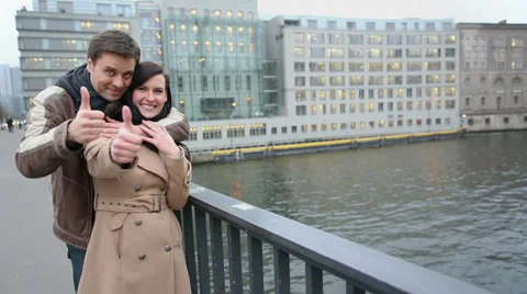 Couple on bridge holding thumbs up Stock Footage 33529014