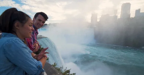 Couple on Bridge Looking at Niagara Falls, Happy Tourists Romantic Stock Footage 102445079
