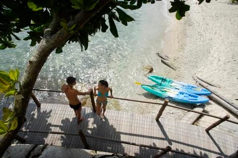Couple on bridge over beach Stock Photos