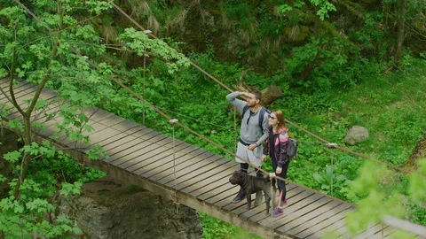 Couple on a bridge, pointing in a direction Stock Footage 99962539