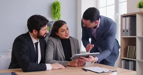Couple In Briefing With Consultant Using Tablet In Office Stock Footage 340541530