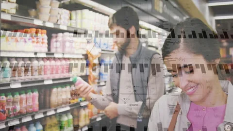 Couple browsing grocery aisle generating fading charts, bar graphs mapping data Stock Footage 313078222