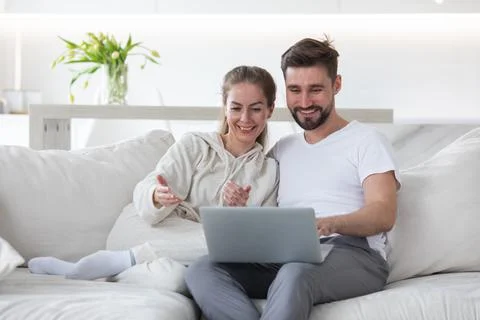 Couple browsing internet in living room Stock Photos