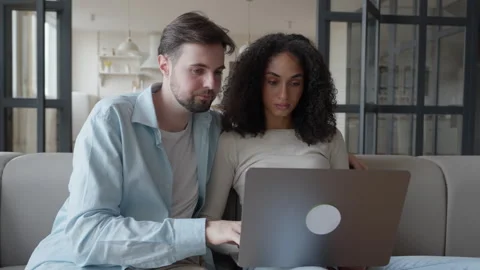 Couple Browsing Online Options Together On Laptop At Cozy Modern Apartment 스톡 동영상 318930712