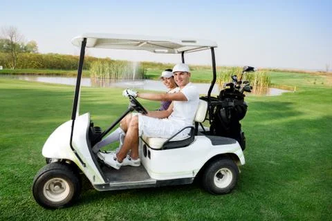 Couple in buggy in golf course Fotos Stock