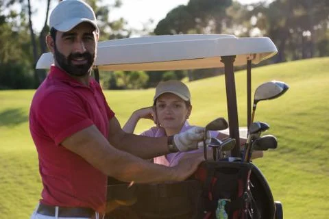 Couple in buggy on golf course Fotos de archivo