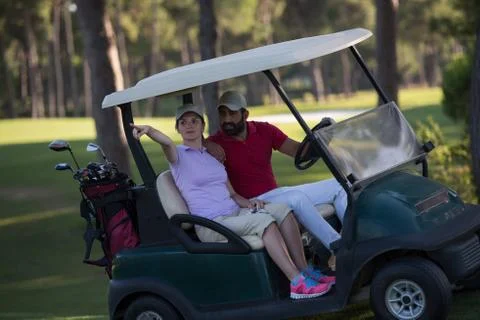 Couple in buggy on golf course Fotos Stock