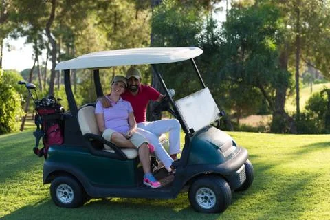 Couple in buggy on golf course Fotos Stock
