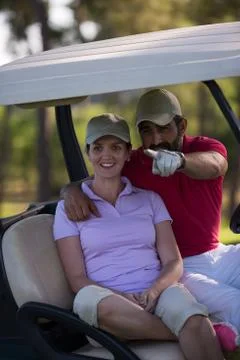Couple in buggy on golf course Fotos Stock