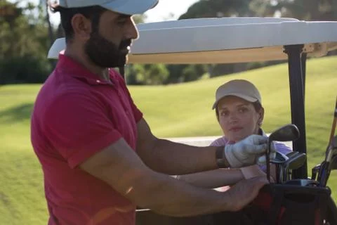Couple in buggy on golf course Fotos Stock