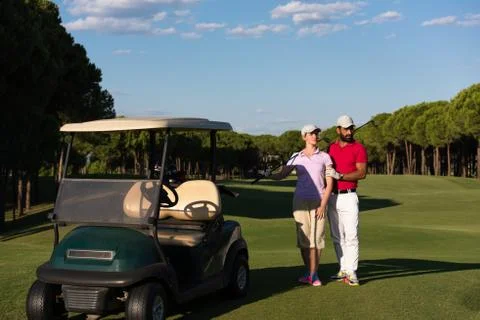 Couple in buggy on golf course Fotos de archivo
