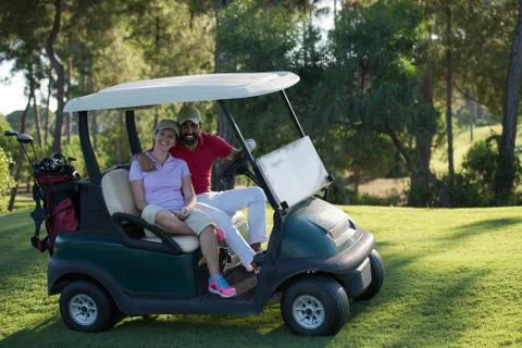 Couple in buggy on golf course Fotos de archivo