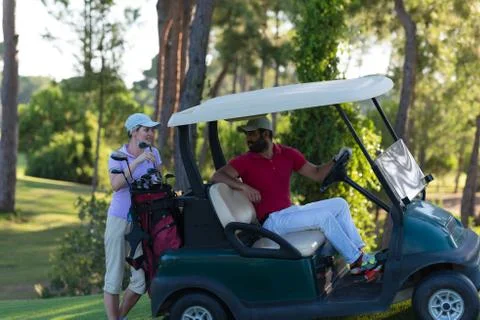 Couple in buggy on golf course Fotos de archivo