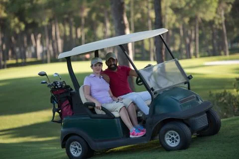 Couple in buggy on golf course Fotos Stock