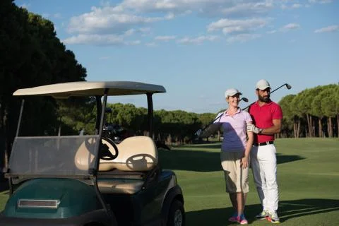 Couple in buggy on golf course Fotos de archivo
