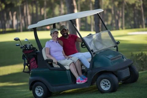 Couple in buggy on golf course Fotos Stock