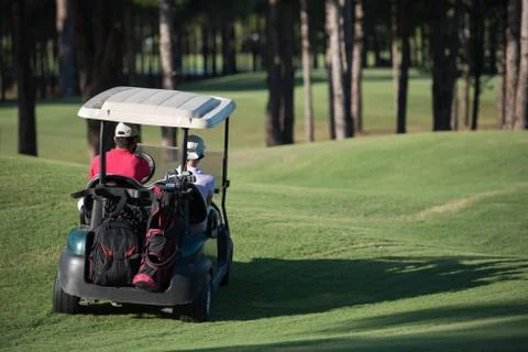 Couple in buggy on golf course Fotos de archivo