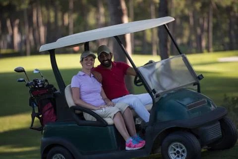 Couple in buggy on golf course Fotos Stock