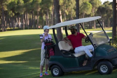 Couple in buggy on golf course Fotos de archivo