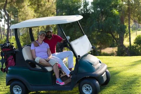 Couple in buggy on golf course Fotos de archivo
