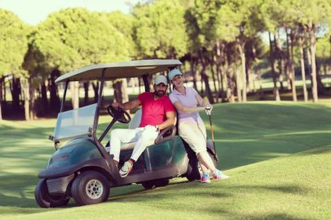 Couple in buggy on golf course Fotos de archivo