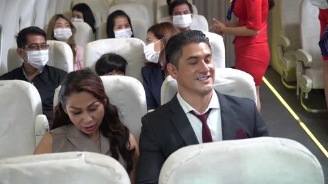 Couple business passengers forget  do not wearing protective face mask sittin Stock Footage 147238096