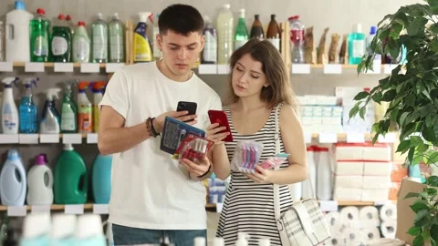 Couple buyer scans qr code on razor label Stock Footage 321720297