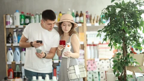 Couple buyer scans qr code on sunblock cream label Stock Footage 321722206