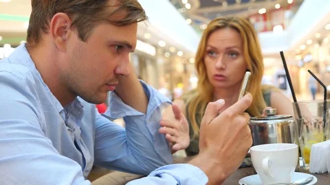 Couple in cafe. beautiful Man and beautiful woman quarrel. 4k, slow-motion Stock Footage 80345585