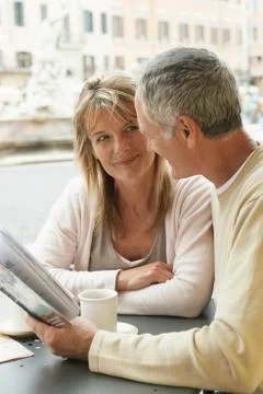 Couple At Cafe Reading Map In Rome Fotos Stock