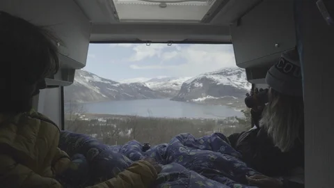 Couple in campervan looking at the scenic view Stock Footage 86176853