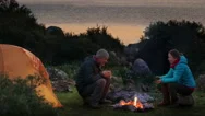 Couple Camping With Campfire And Tent Outdoors Stock Footage
