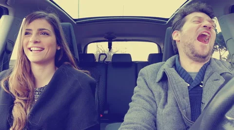Couple in car laughing having fun retro vintage color graded look 4K Stock Footage 61788257