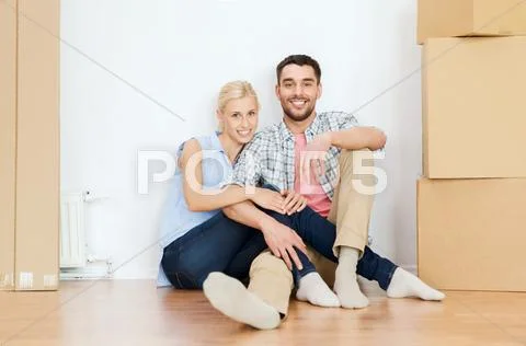 Couple with cardboard boxes moving to new home Stock Photos