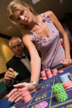 Couple in casino playing roulette (selective focus) Stock Photos