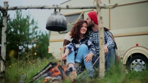 Couple in a checkered plaid roasting marshmallows on fire near the trailer home. Stock Footage 152183188