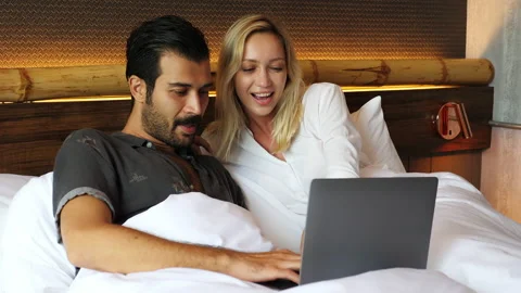 Couple checking information of business online on laptop computer husband and wi Stock Footage 137449528